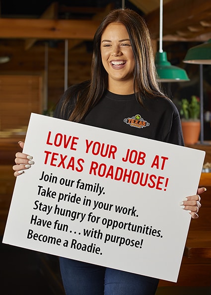 Employee holding a sign