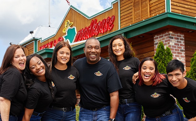 Employees in front of a restaurant